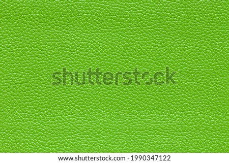 Background image - green leather with textured abstract pattern.