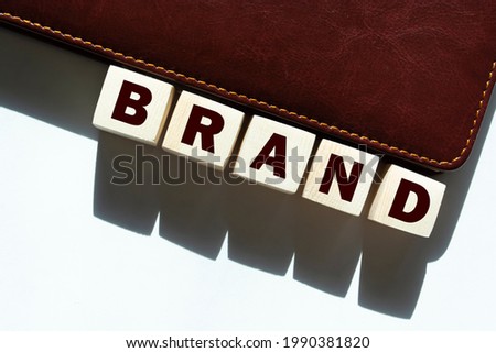 Phrase BRAND on wooden cubes isolated on white background. Business concept.