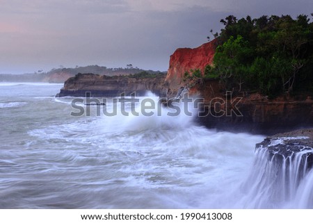 picture of cliff with blue water waves in Bengkulu Indonesia, sea view from above the view from the top of the mountain. Travel paradise destination for adventure.