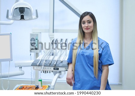 Young female dentist atanding in clinic. Concept, medicine - health