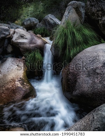 long exposure of a small waterfall between rocks. 