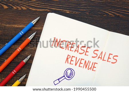 Financial concept meaning Increase Sales Revenue with sign on the piece of paper. 
