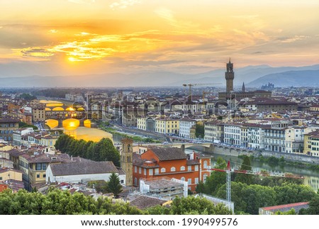 Vivid sunset over river Arno in Florence seen from Michelangelo square. In the picture could be seen Cathedral Santa Maria del Fiore, city hall Palazzo Vecchio and famous bridge Ponte Vecchio 