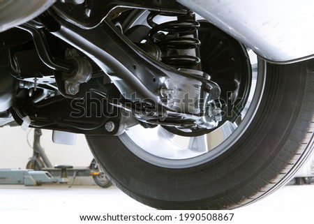 Elements and structure of the suspension of a modern car. Service, spare parts, car repair.                                Royalty-Free Stock Photo #1990508867