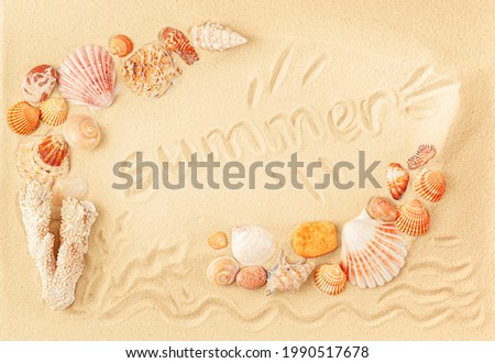 Word summer written on the sand inside frame of seashells. Overhead, flat lay. 