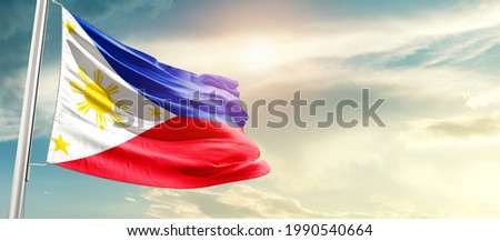 Philippines national flag waving in beautiful sunlight. Royalty-Free Stock Photo #1990540664