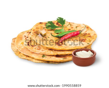 
Potato Stuffed Flat Bread or Aloo paratha is a Traditional Indian food. served with curd, butter or ghee. selective focus. isolated on white background. Royalty-Free Stock Photo #1990558859