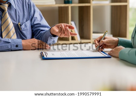 Close up of Business people working about colleagues or investment professional document agreement signing lawyers discussing contract negotiation at modern office,