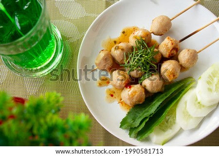 Grilled meatballs are served on a beautifully decorated table.