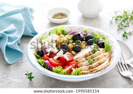 Chicken breast grilled and Greek salad with chickpeas and feta cheese