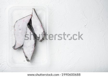 Halibut fish frozen steak pack set, on white stone table background, top view flat lay, with copy space for text