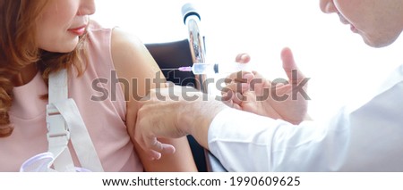 Doctors vaccinating woman patients.
patient is giving the injection in the hospital