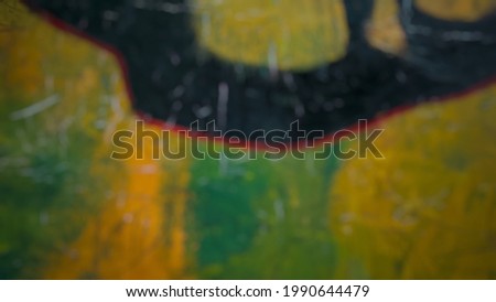 Defocused object of Abstract acrylic background with main colors black, green and yellow. Blurred Photo.