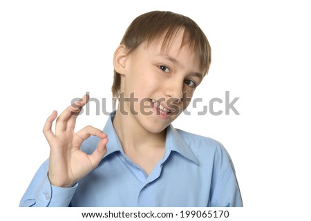 Young smiling boy showing ok isolated on white background