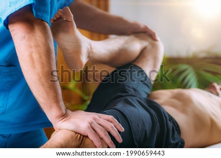 Chiropractic manual manipulation spine adjustment. Therapist treating patient’s back. Discus hernia or herniated disc treatment. Royalty-Free Stock Photo #1990659443