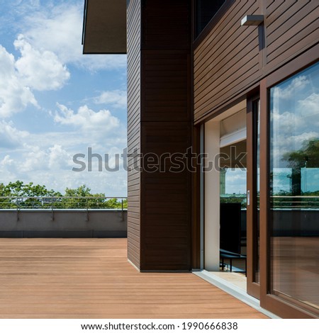 Spacious and nice terrace with wooden floor and walls, exterior view Royalty-Free Stock Photo #1990666838
