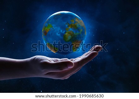 Human hand holding planet earth