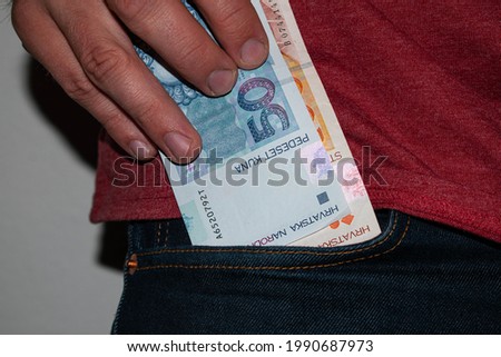 Croatian kuna banknotes in jeans pocket Royalty-Free Stock Photo #1990687973
