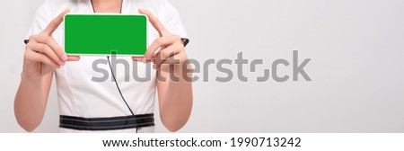 Beautiful Asian woman holding blank screen smartphone on white background