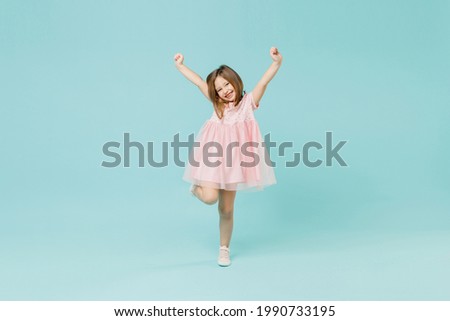 Full size body length little fun cute kid girl 5-6 years old wears pink dress dancing isolated on pastel blue color background child studio portrait. Mother's Day love family people lifestyle concept Royalty-Free Stock Photo #1990733195