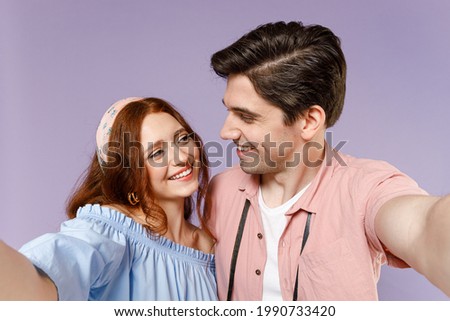Two fun traveler tourist woman man couple in casual clothes do selfie shot on mobile phone isolated on purple background Passenger travel abroad weekend getaway Air flight journey relationship concept