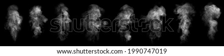 Set. Close-up of steam or abstract white smog rising above. water droplets that can be seen that swirl beautifully from humidifier spray. Isolated on a black background Royalty-Free Stock Photo #1990747019