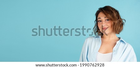 Flyer. Young Caucasian beautiful woman in casual clothes isolated on light blue background. Concept of human emotion, facial expression, beauty, fashion. Copy space for ad