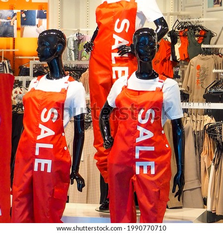 shopping mannequins in clothing with the inscription sale 
