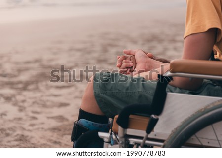 Handicapped children in wheelchairs hold their parents' hands, Positive strengthening by family from parents to disabled person, Happy disability child concept. Royalty-Free Stock Photo #1990778783