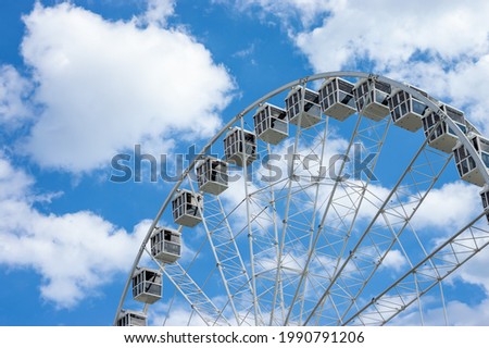Ferris wheel in a sunny day with white clouds in europe - Summer empty copy space area background