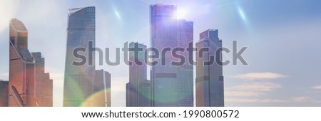 Silhouettes of business skyscrapers and modern office buildings of Moscow City against the sky with sunlight. Business and economics background