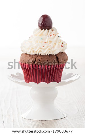 cupcakes decorated with whipped cream and cherries