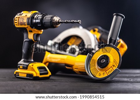 Construction carpentry tools electric corded circular saw cordless drill on background Royalty-Free Stock Photo #1990854515