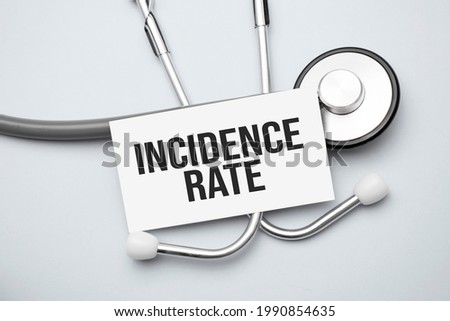 Paper with incidence rate on a table and grey stethoscope
