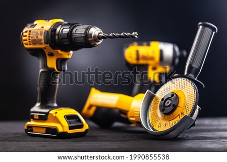 Construction carpentry tools electric corded circular saw cordless drill on background Royalty-Free Stock Photo #1990855538
