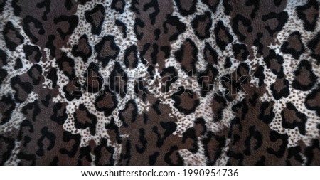 Brown leopard wool texture with black spots, artificial sewing material