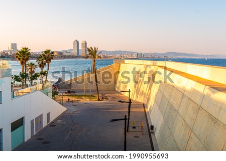 Picture of Barceloneta beach and barcelona towers, captured in a sunny day. Mediterranean sea.