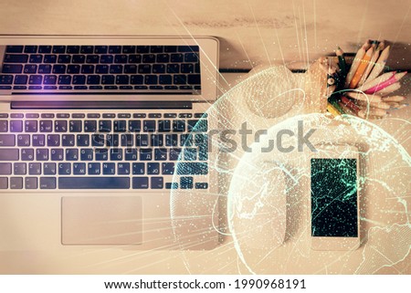 Social network hologram drawings over computer on the desktop background. Top view. Multi exposure. Concept of people connection.