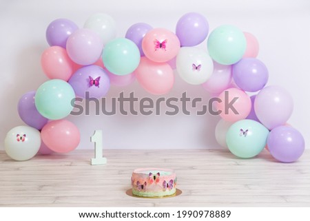 Fantastic colorful birthday girl cake with pastels balloons. Butterfly cake. Girl birthday celebration. Baby's first year. First year photoshoot.