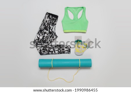 Yoga fashion sportwear outfit flatlay stilllife shot from above isolated on grey background Royalty-Free Stock Photo #1990986455