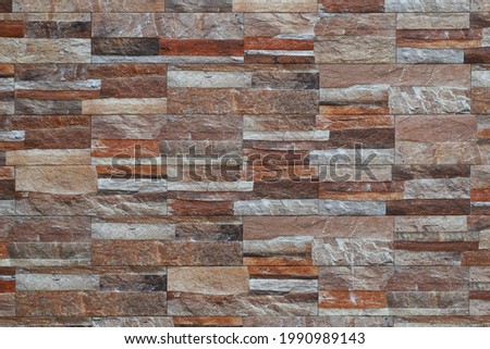 Wall layer made by various colour of natural stone bricks