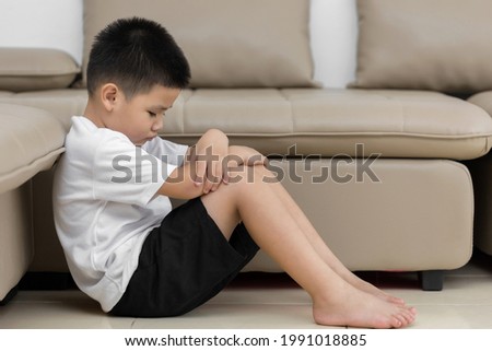 Asian child  sitting alone with sad feeling, Concept for bullying, depression stress or frustration Royalty-Free Stock Photo #1991018885