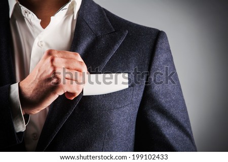 business man takes out business card from the pocket of business suit, copyspace