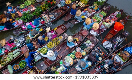 Famous floating market in Thailand, Damnoen Saduak floating market, Farmer go to sell organic products, fruits, vegetables and Thai cuisine, Tourists visiting by boat, Ratchaburi, Thailand. Royalty-Free Stock Photo #1991033339