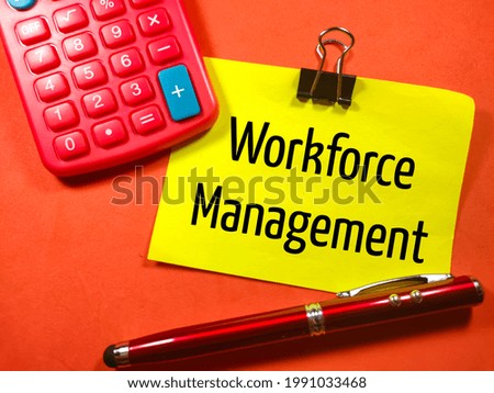 Business concept.Text WORKFORCE MANAGEMENT on colorful paper note with calculator and pen on red background.