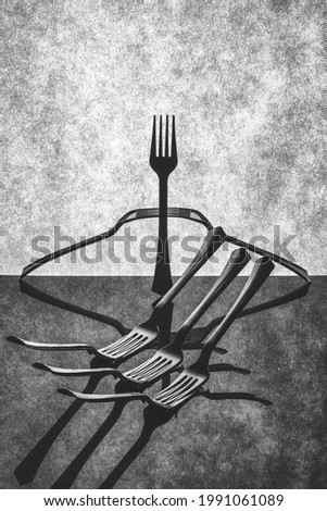Very simple still life with forks on gray background