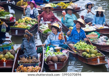 Famous floating market in Thailand, Damnoen Saduak floating market, Farmer go to sell organic products, fruits, vegetables and Thai cuisine, Tourists visiting by boat, Ratchaburi, Thailand. Royalty-Free Stock Photo #1991070896