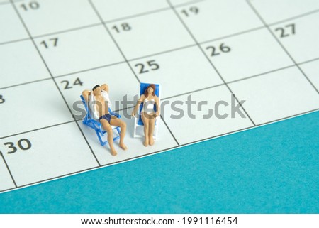 Miniature people toy figure photography. Travel plan schedule concept, a couple men and girl relaxing at beach chair with calendar. Image photo