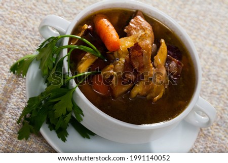 Image of tasty scottish traditional soup cock-a-leekie with chicken, bacon and leek Royalty-Free Stock Photo #1991140052
