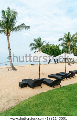 empty beach chair with palm tree on beach with sea background
